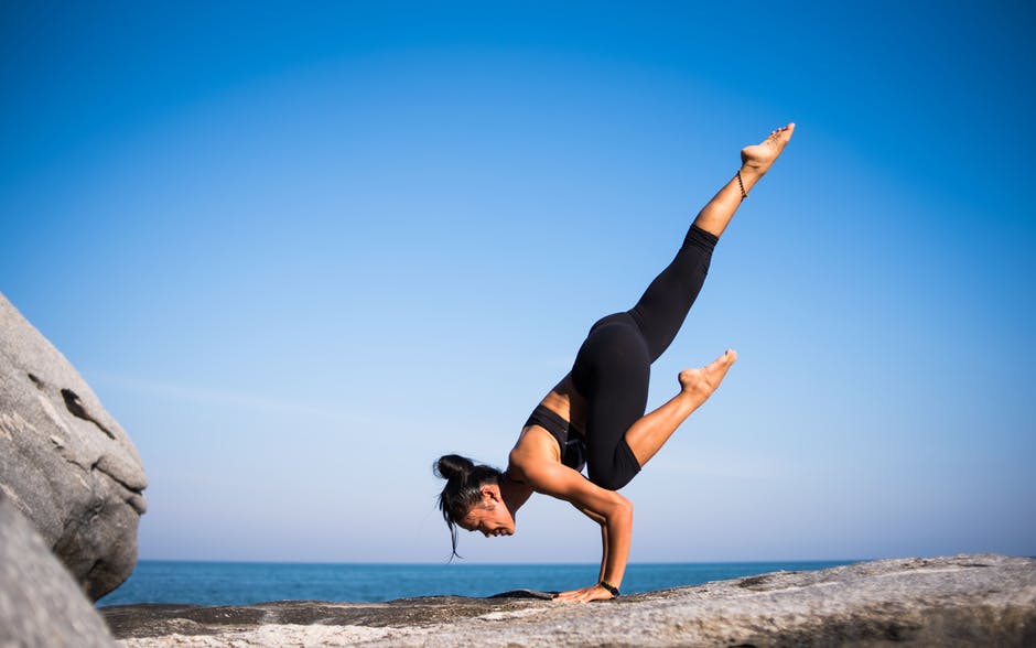woman exercising yoga on period
