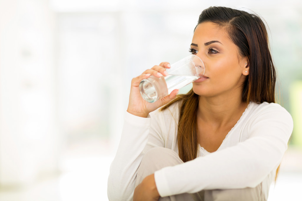 Eczema skin drinking glass of water